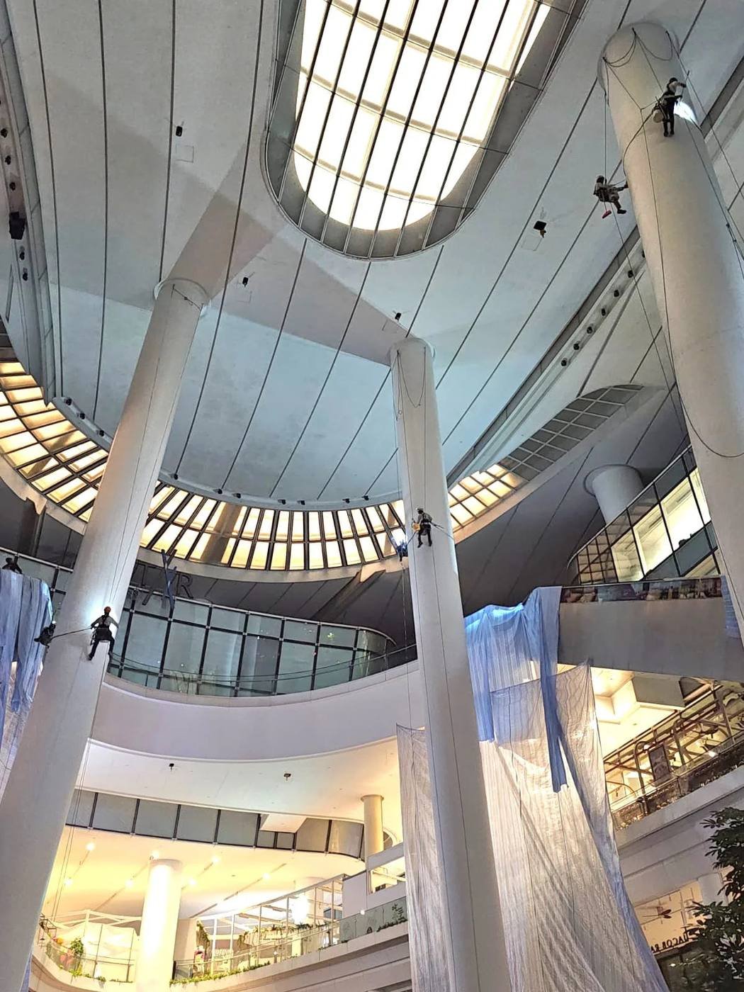 rope access technicians working on atrium columns inside a Singapore mall